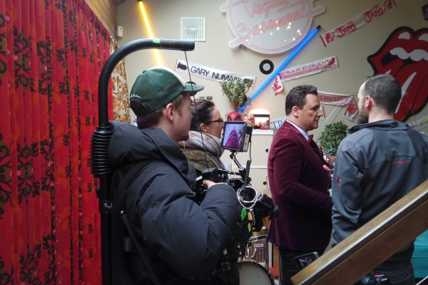 wo-person camera crew filming a corporate interview in a Dublin studio